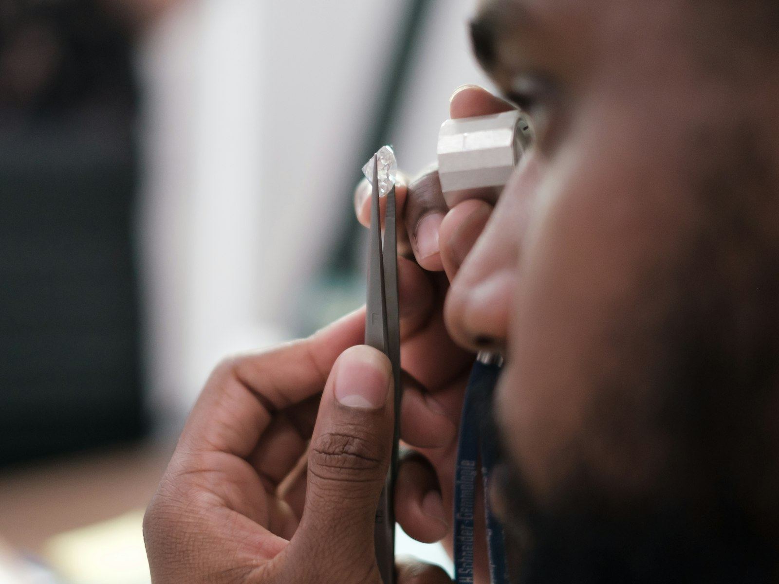 Close-up side view of an otoscope being used to examine a man's ear